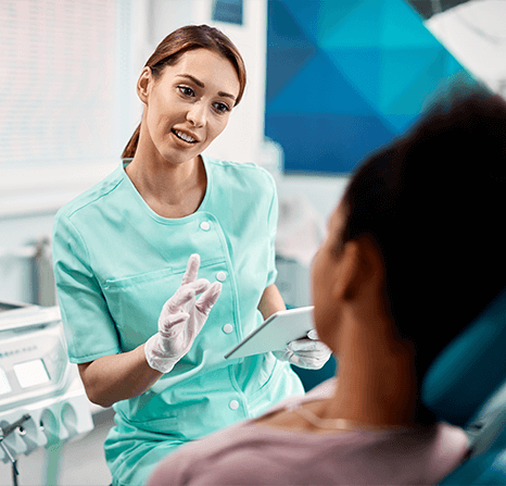 Dentist explaining something to patient.